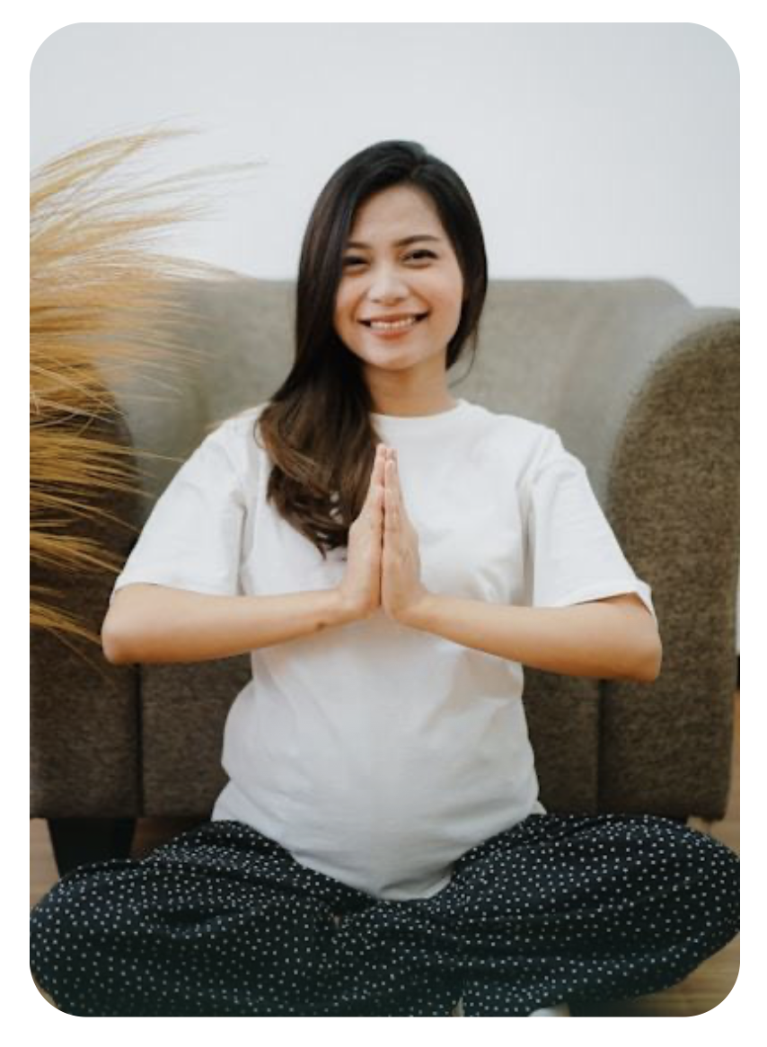 Pregnant woman meditating indoors